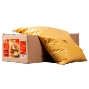 Savory cheese sauce in a sealed plastic bag placed on a cardboard box, ready for distribution or sale, with an emphasis on quality cheese and food packaging.